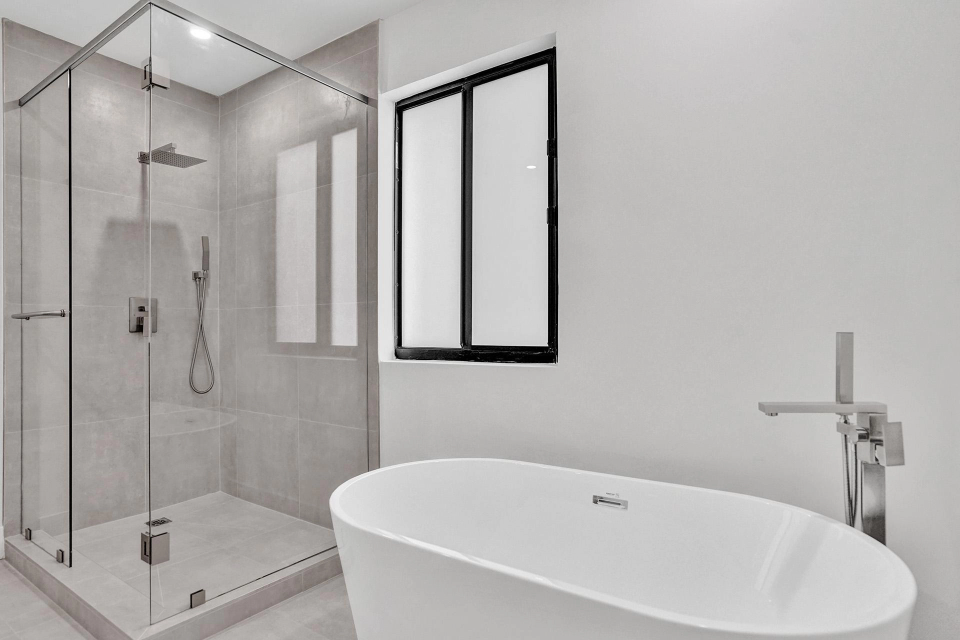 Shore Crest Miami home renovation second bathroom with tub and rainfall shower