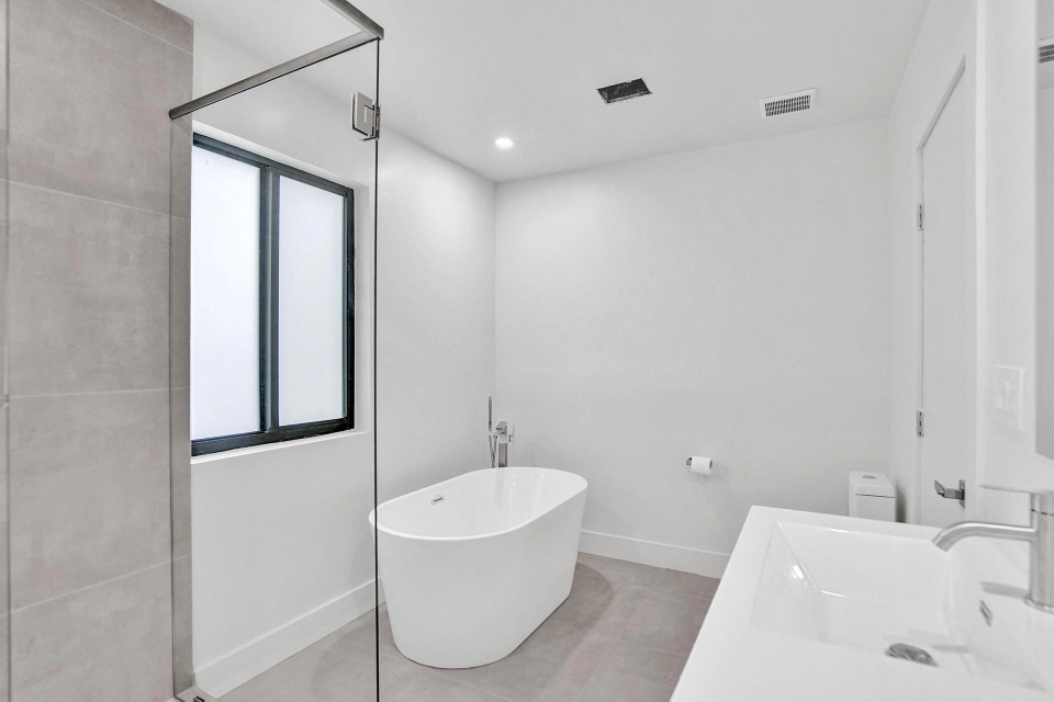 Shore Crest Miami home renovation secondary bedroom with ample closet space