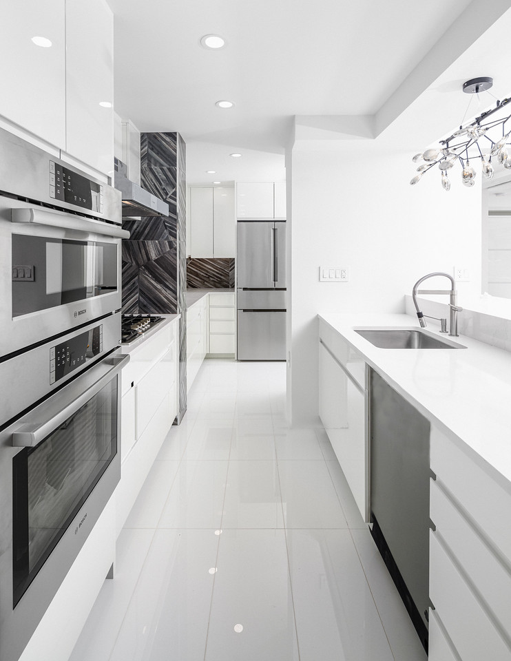 Modern kitchen renovation in Upper West Side duplex apartment featuring high-end lacquered cabinets