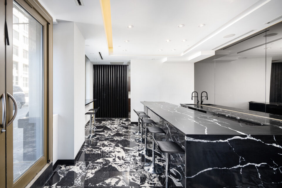 NestSeekers office bar area with antique mirrors and black ceramic tiles