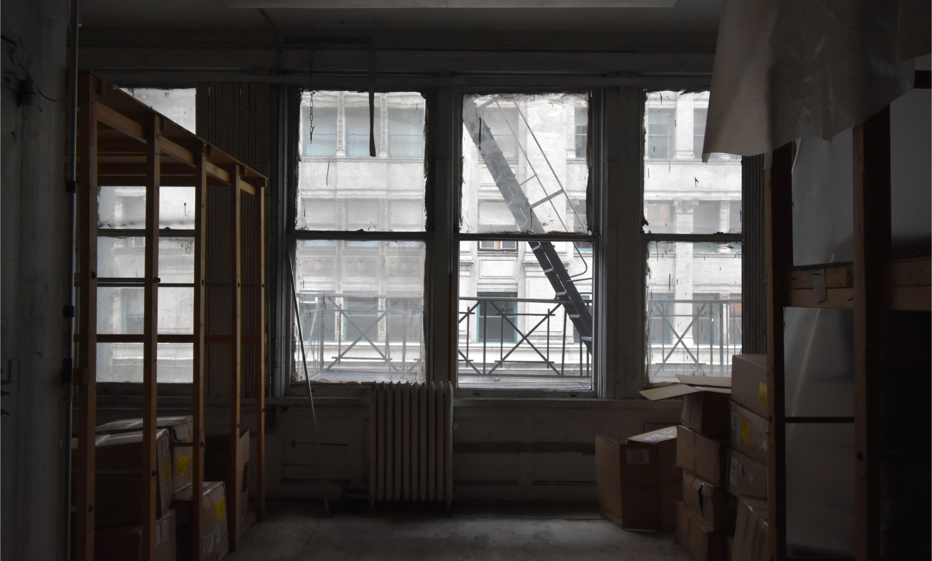 SoHo office renovation before photo showing outdated warehouse area