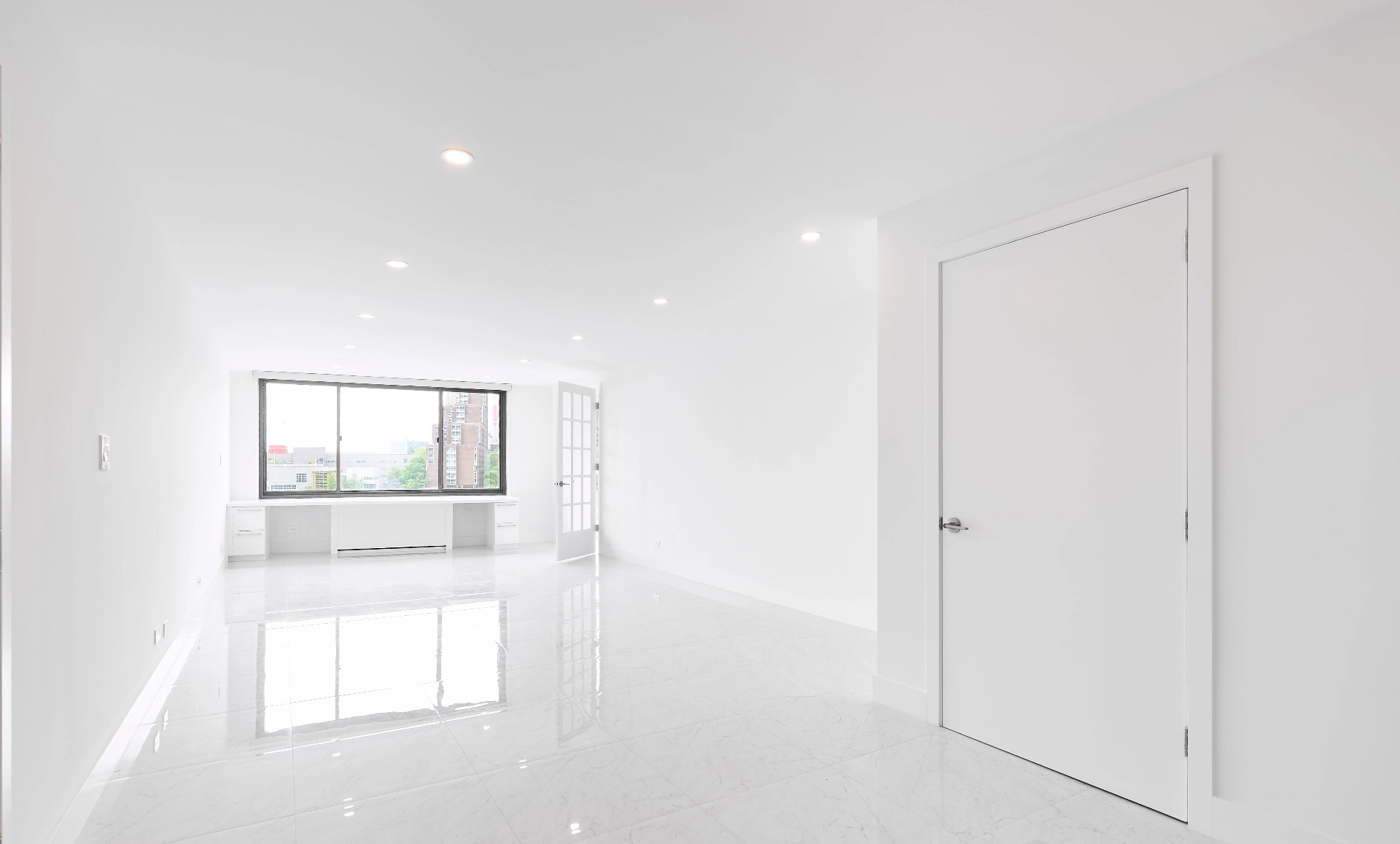 UES apartment renovation after photo showing accessible living room with custom desk