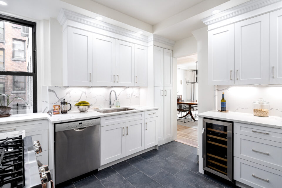 UES apartment renovation after photo showing modernized kitchen with Calacatta quartz