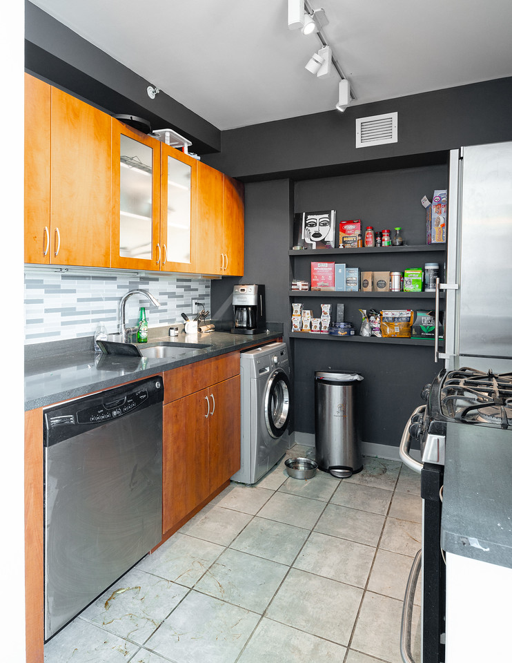 Kitchen before renovation showing cramped layout and outdated fixtures
