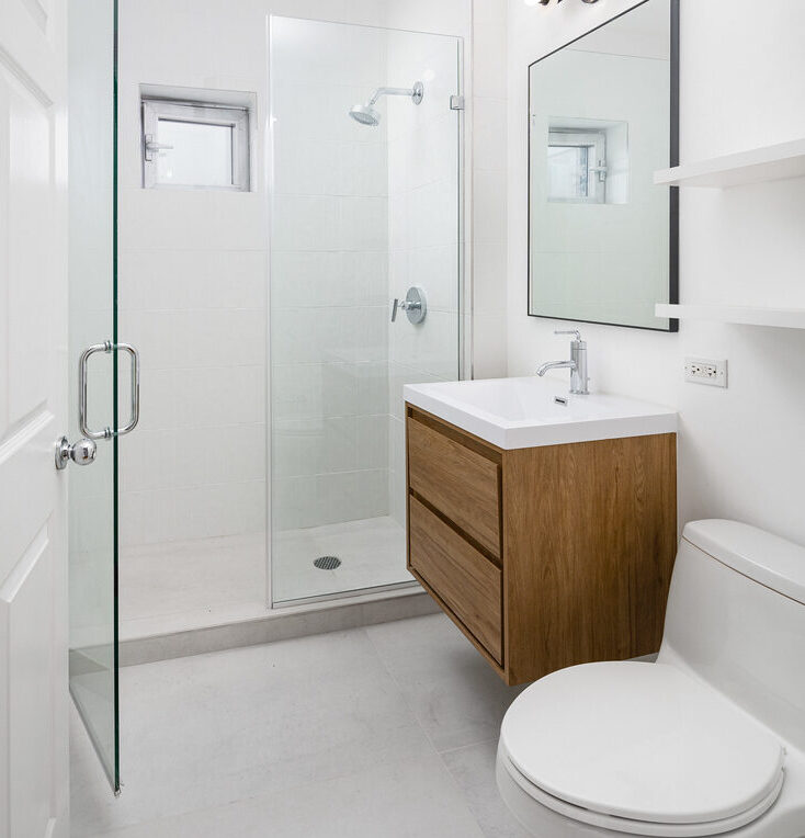 Bathroom after renovation with grey floor tiles and white subway tiles