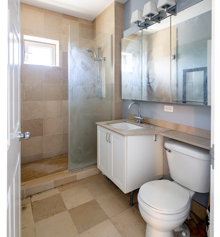 Bathroom before renovation showing outdated fixtures and layout