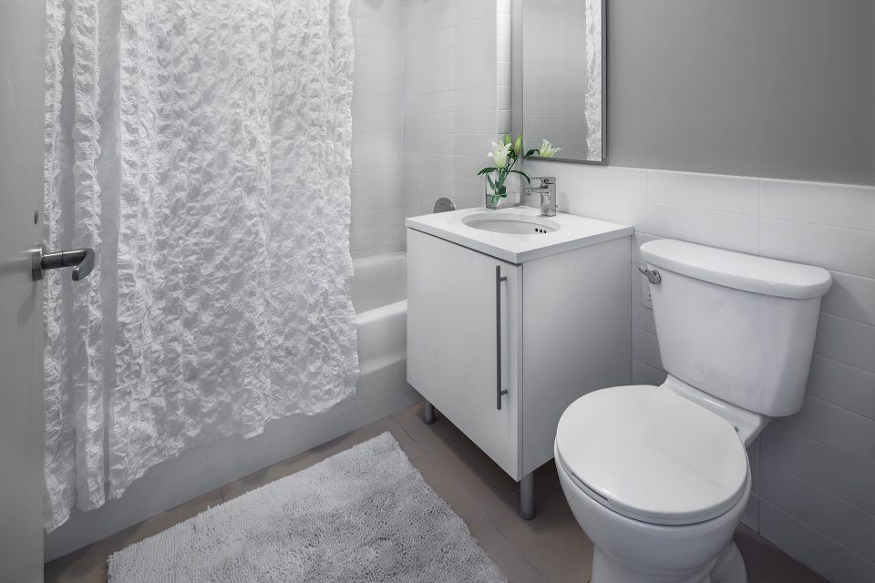 Upper West Side condo bathroom with grey matte porcelain floor tiles and Italian vanity
